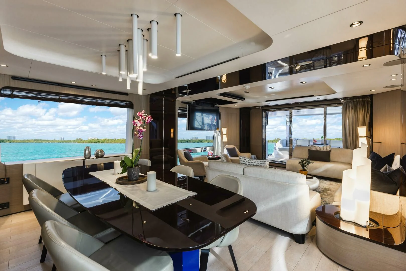 a room with a table chairs and a large window aboard MAJESTIC MOMENTS Yacht for Sale