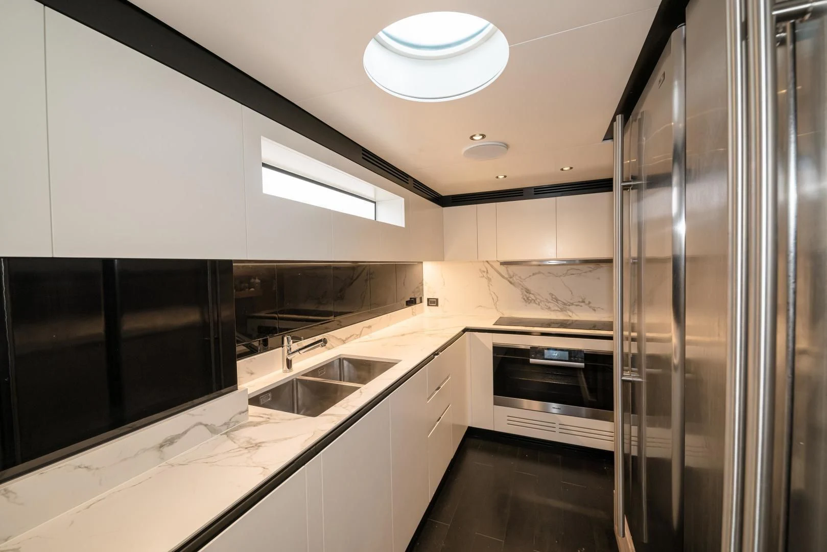 a kitchen with stainless steel appliances aboard MAJESTIC MOMENTS Yacht for Sale