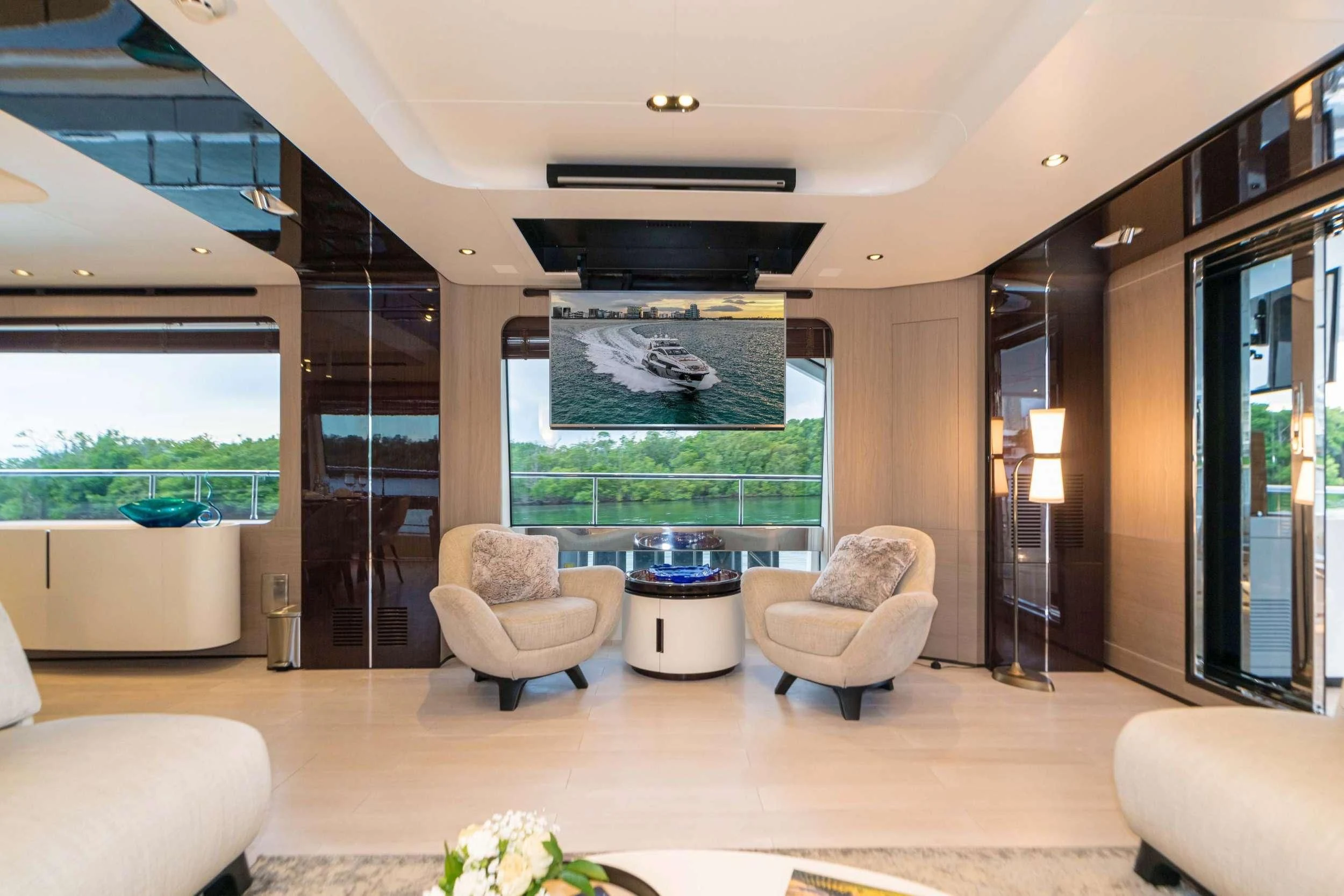 a living room with a large glass wall aboard MAJESTIC MOMENTS Yacht for Sale