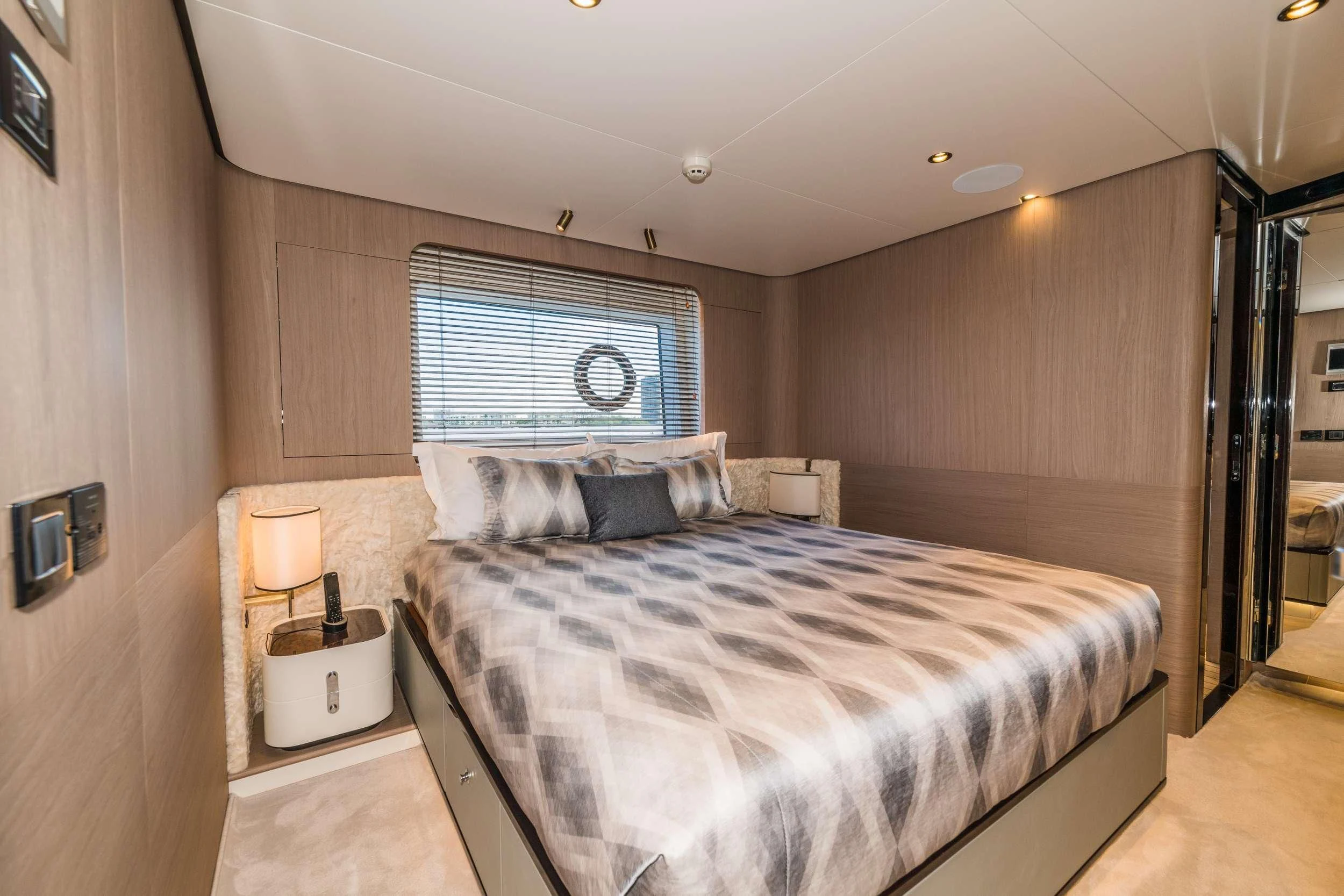 a bedroom with a bed and a window aboard MAJESTIC MOMENTS Yacht for Sale