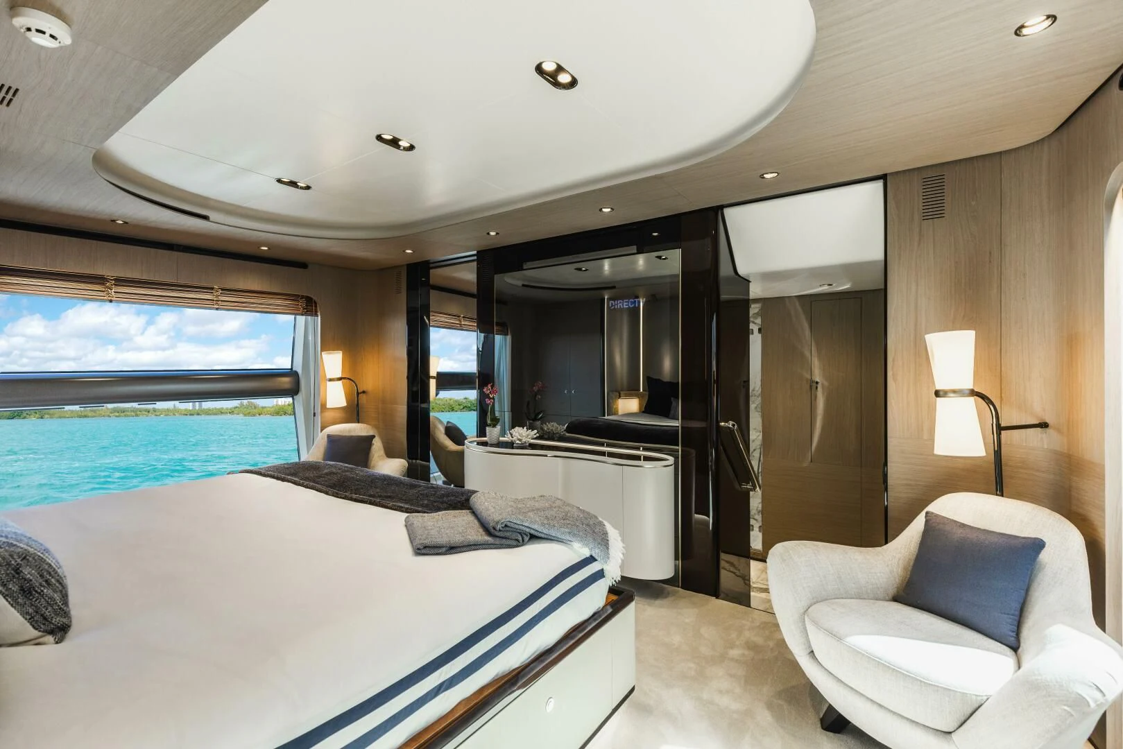 a hotel room with a bed and a chair aboard MAJESTIC MOMENTS Yacht for Sale