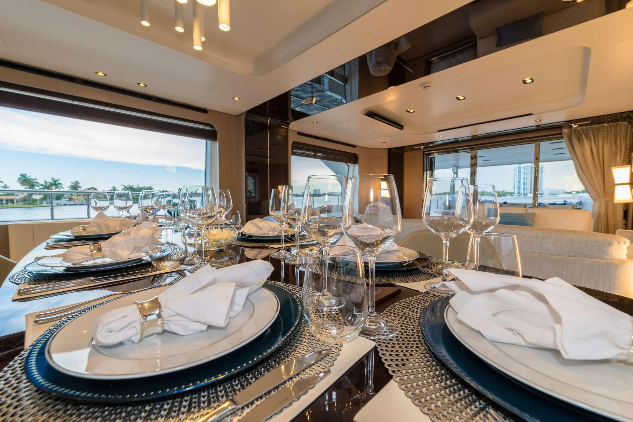 a table with plates and glasses aboard MAJESTIC MOMENTS Yacht for Sale