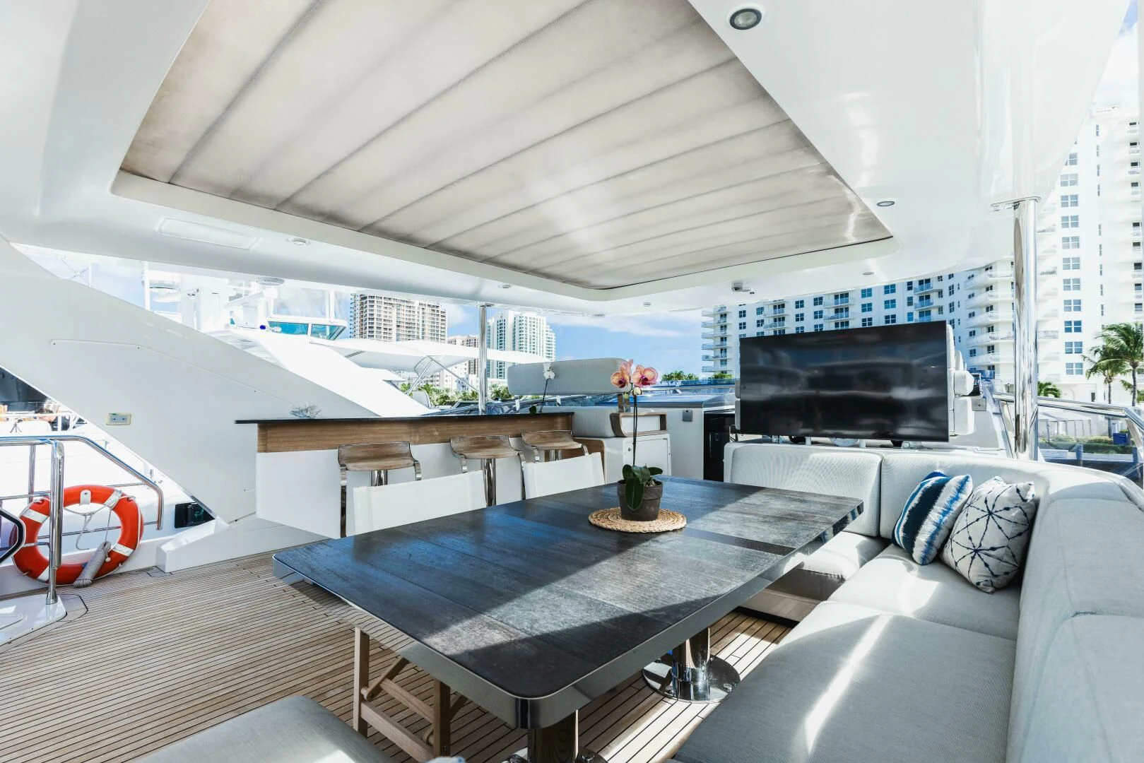 a room with a table and a couch aboard MAJESTIC MOMENTS Yacht for Sale