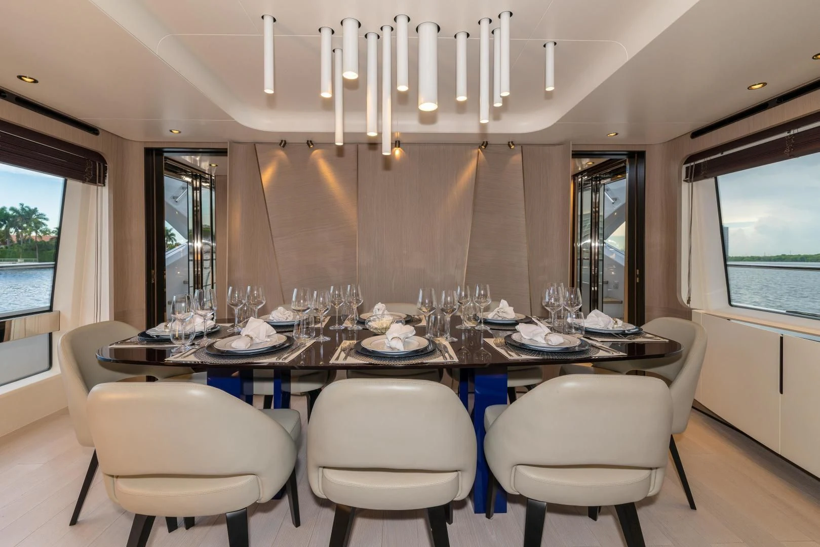 a dining table with white chairs aboard MAJESTIC MOMENTS Yacht for Sale