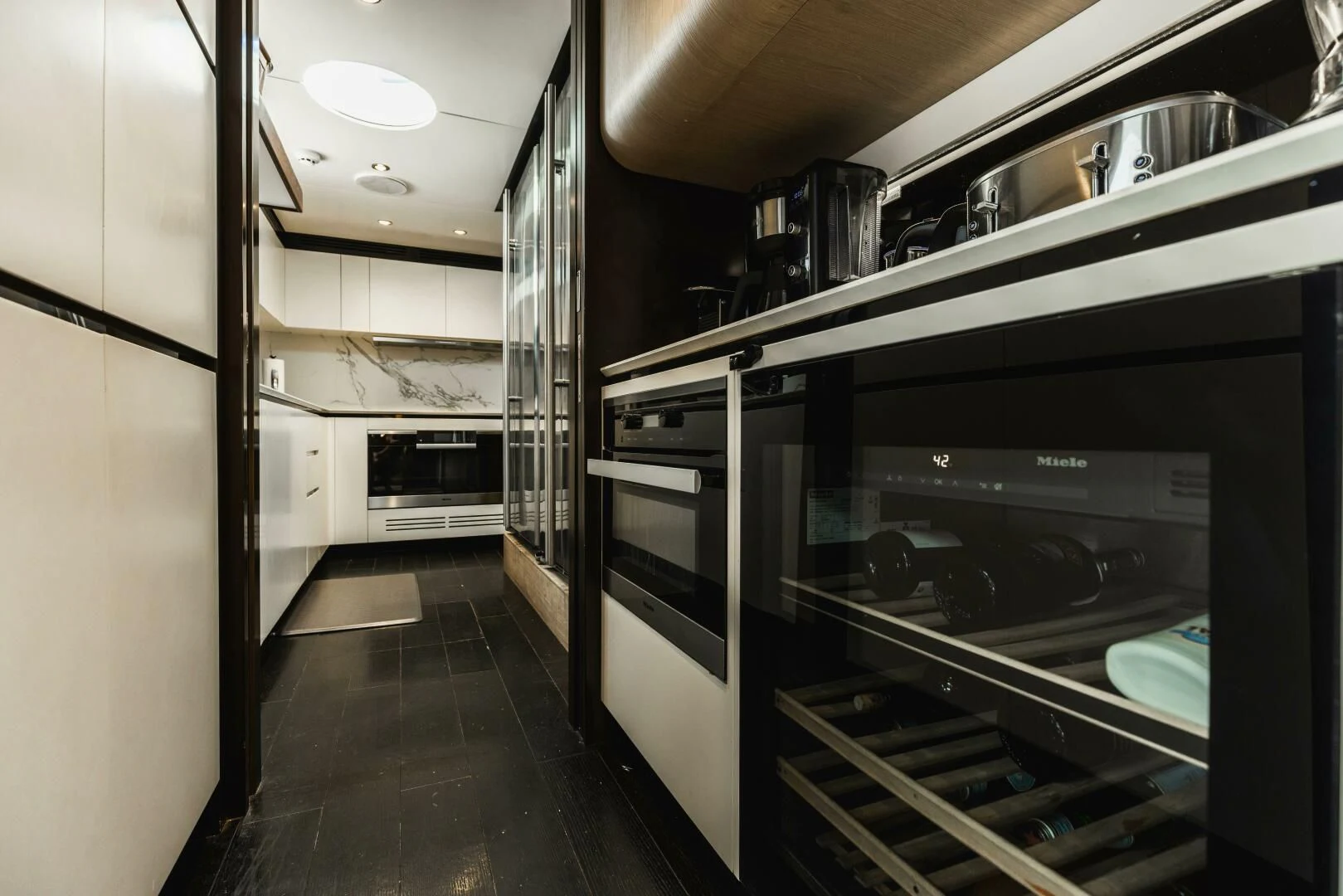 a kitchen with stainless steel appliances aboard MAJESTIC MOMENTS Yacht for Sale