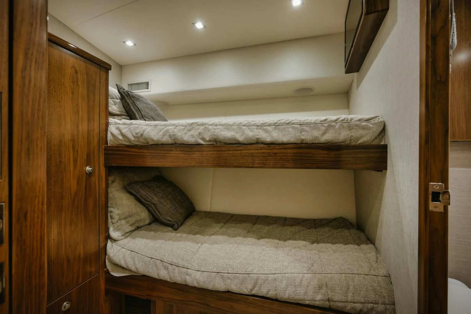 a bed with a wooden frame aboard WHY WOULDN'T WE Yacht for Sale