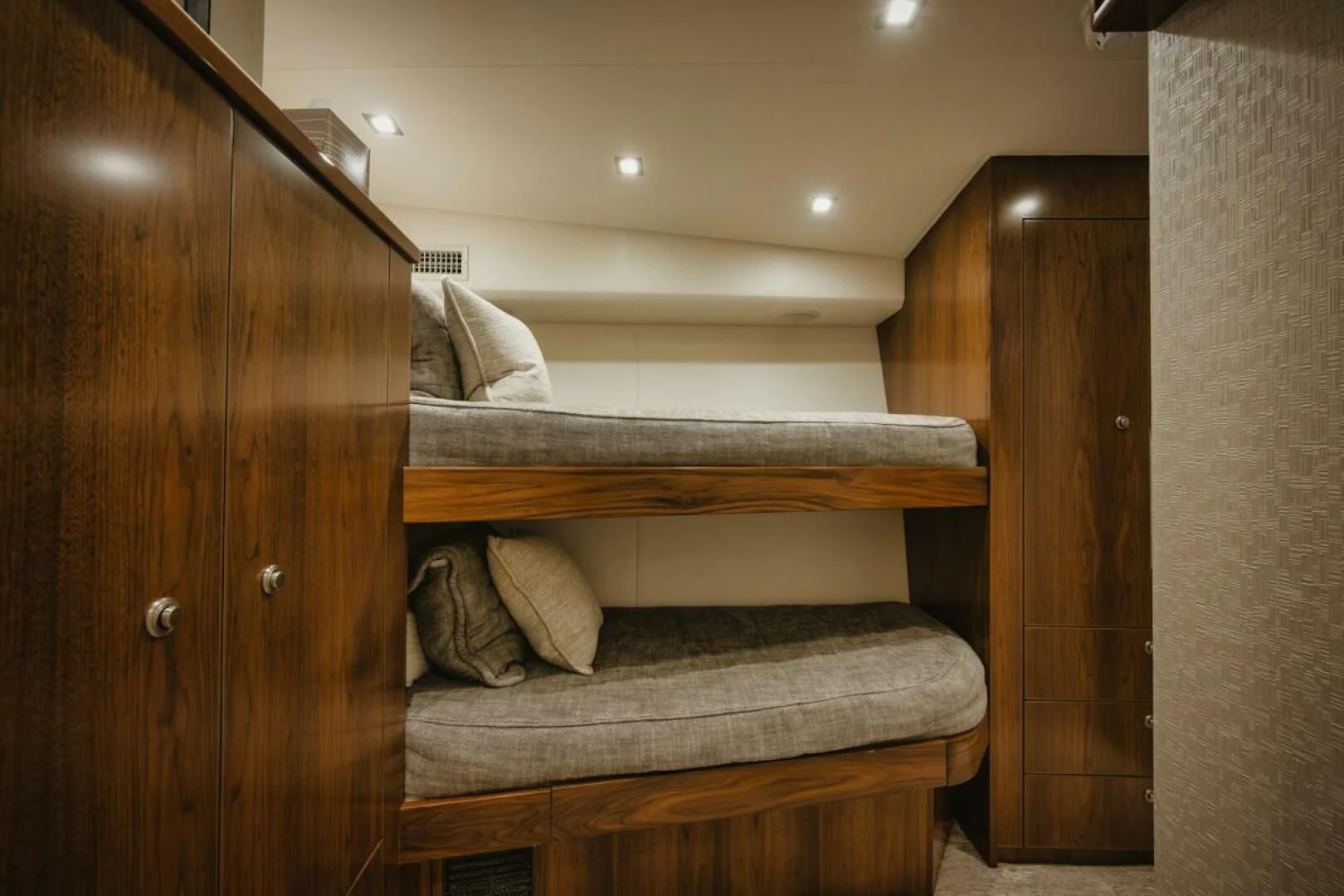 a bed with a wooden headboard aboard WHY WOULDN'T WE Yacht for Sale