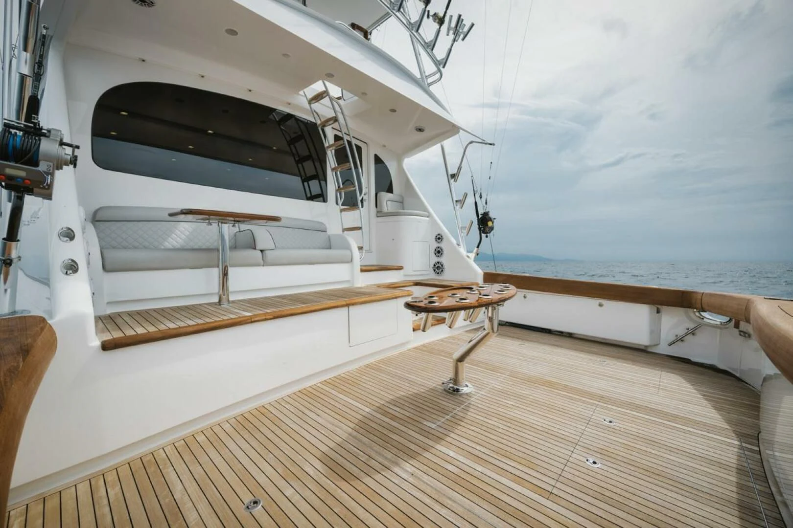 a large white boat on a wooden deck aboard WHY WOULDN'T WE Yacht for Sale
