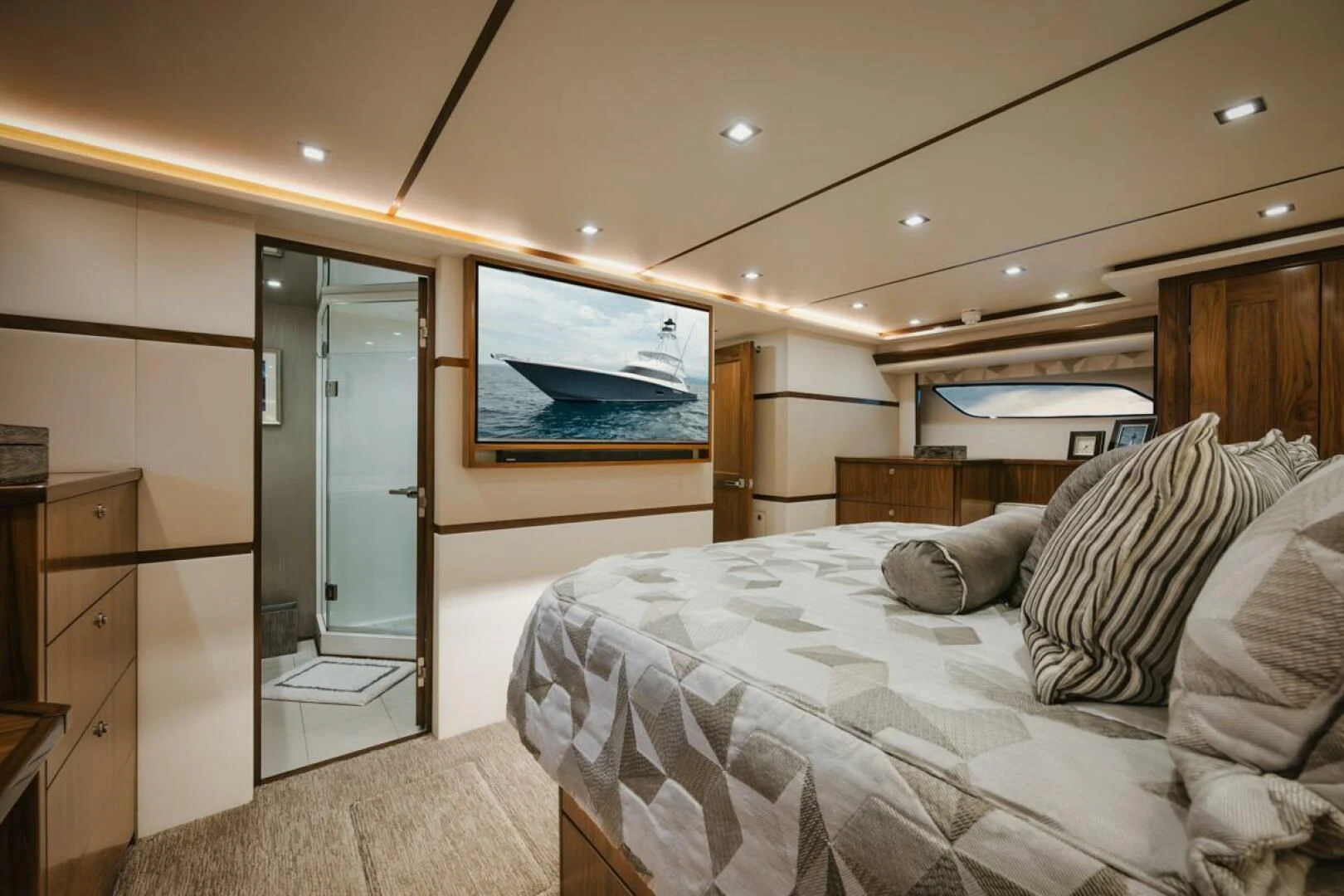 a bedroom with a bed and a mirror aboard WHY WOULDN'T WE Yacht for Sale