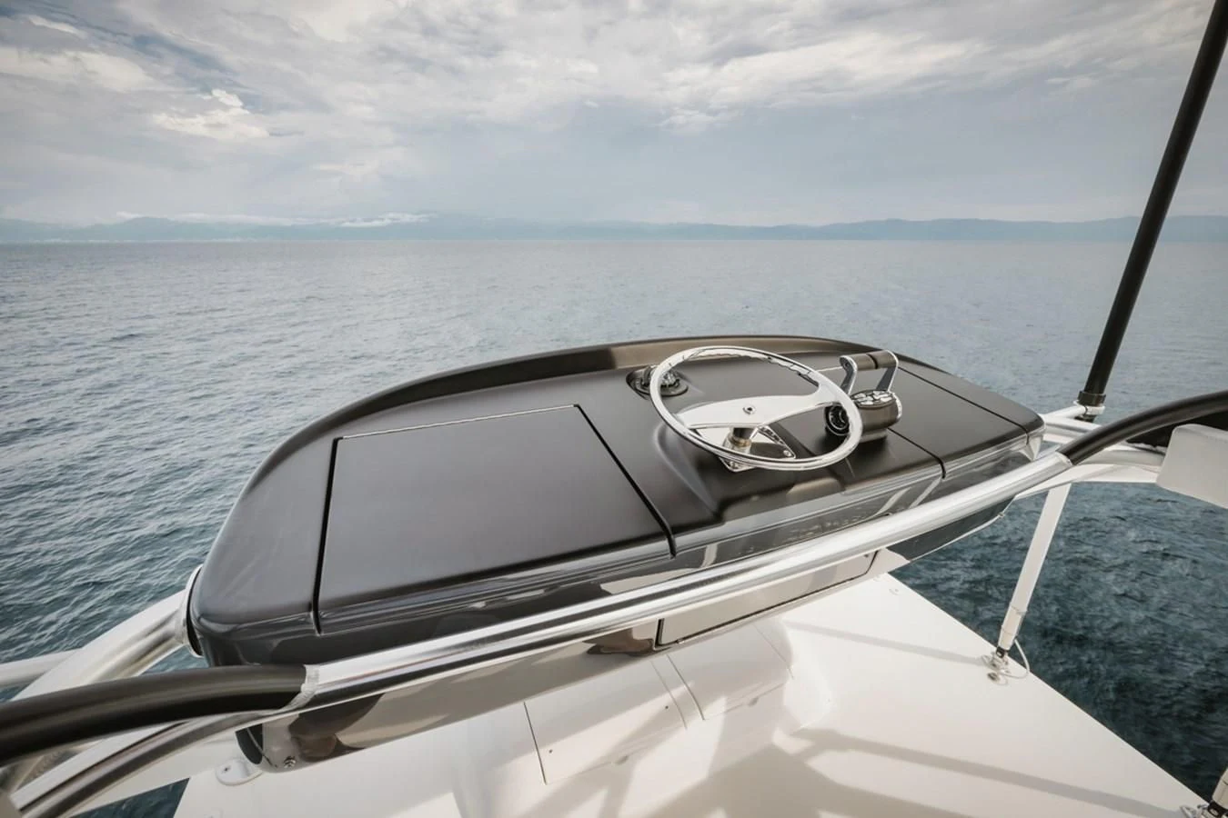 a boat with a steering wheel and a view of the water aboard WHY WOULDN'T WE Yacht for Sale