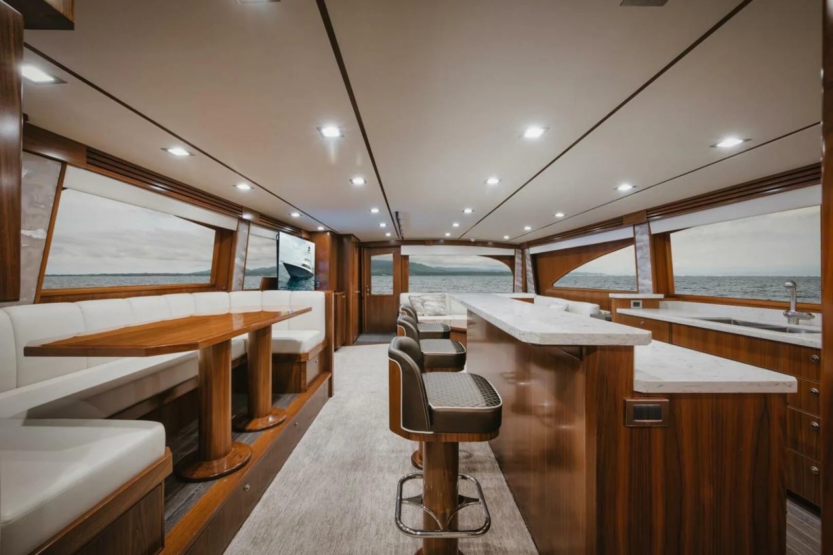 a room with a desk and chairs aboard WHY WOULDN'T WE Yacht for Sale
