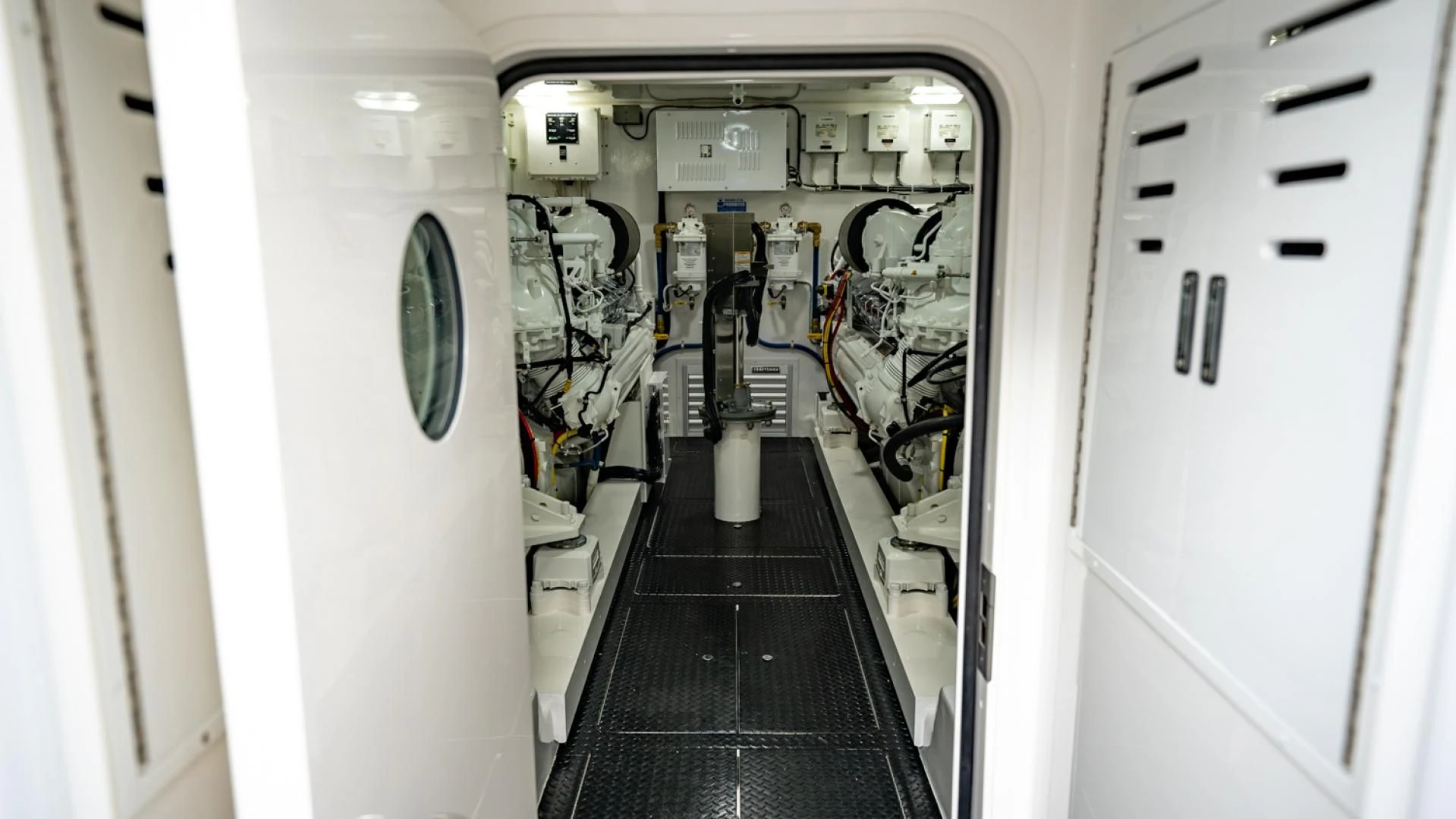 a hallway with a row of white doors and a black floor aboard WHY WOULDN'T WE Yacht for Sale