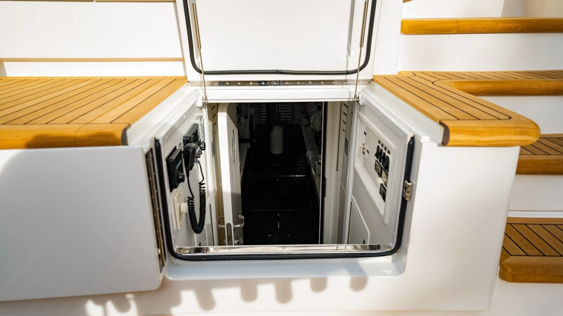 a white microwave with a door open aboard WHY WOULDN'T WE Yacht for Sale