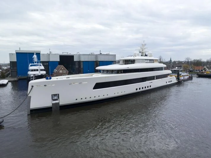 a large white boat in a harbor aboard SIBELLE Yacht for Sale