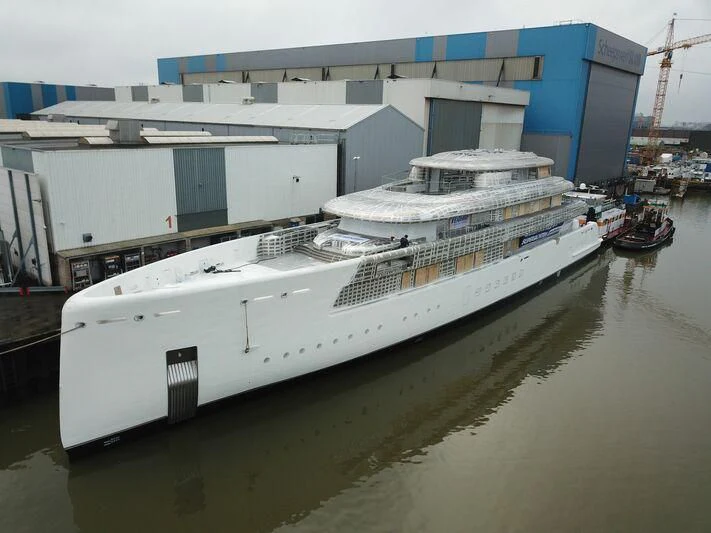 a large white boat in a harbor aboard SIBELLE Yacht for Sale