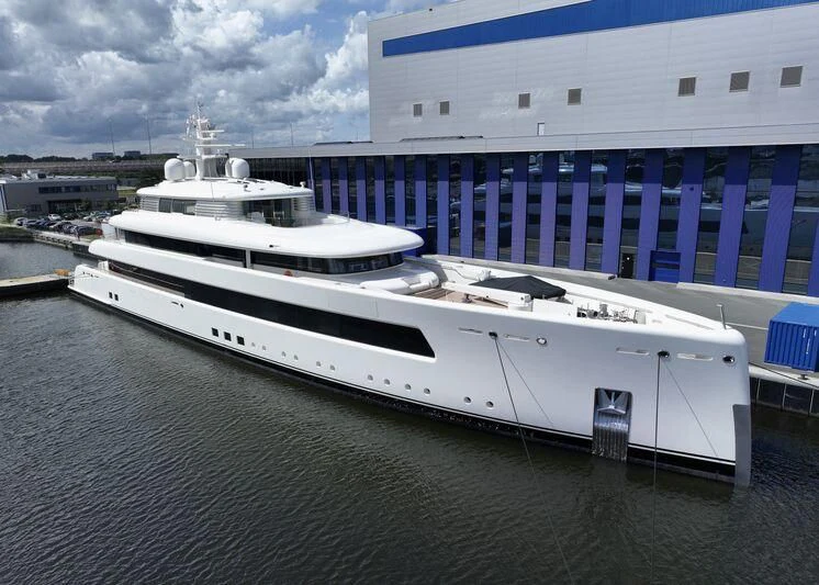 a large white boat in a harbor aboard SIBELLE Yacht for Sale
