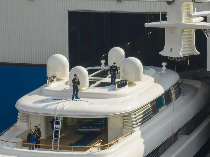 a group of people standing on a white object with a white object on top aboard SIBELLE Yacht for Sale