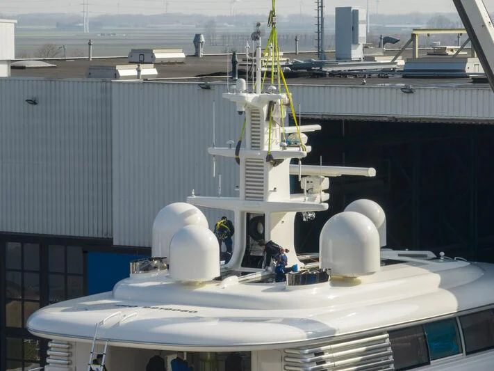 a large white machine with a yellow crane on top aboard SIBELLE Yacht for Sale