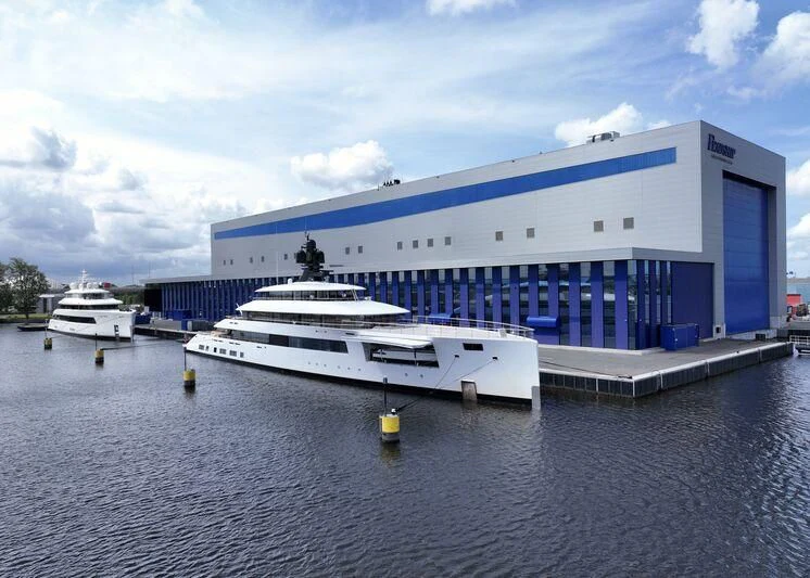 a large cruise ship docked aboard SIBELLE Yacht for Sale