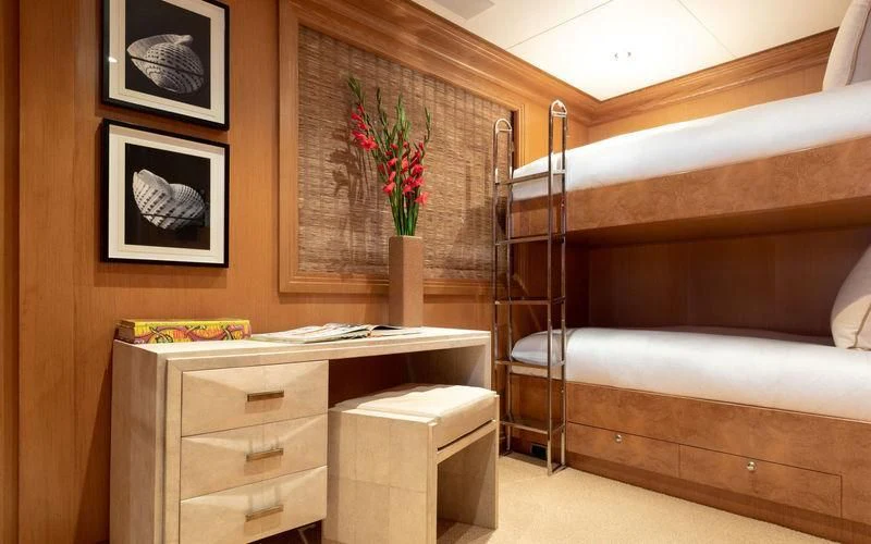 a wooden bunk bed with a flower vase on top of it aboard TREEHOUSE Yacht for Sale