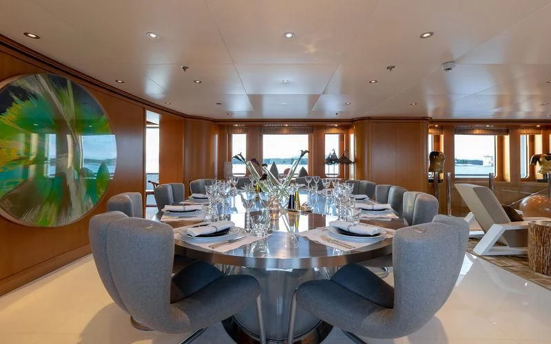 a large dining room with a large screen aboard TREEHOUSE Yacht for Sale