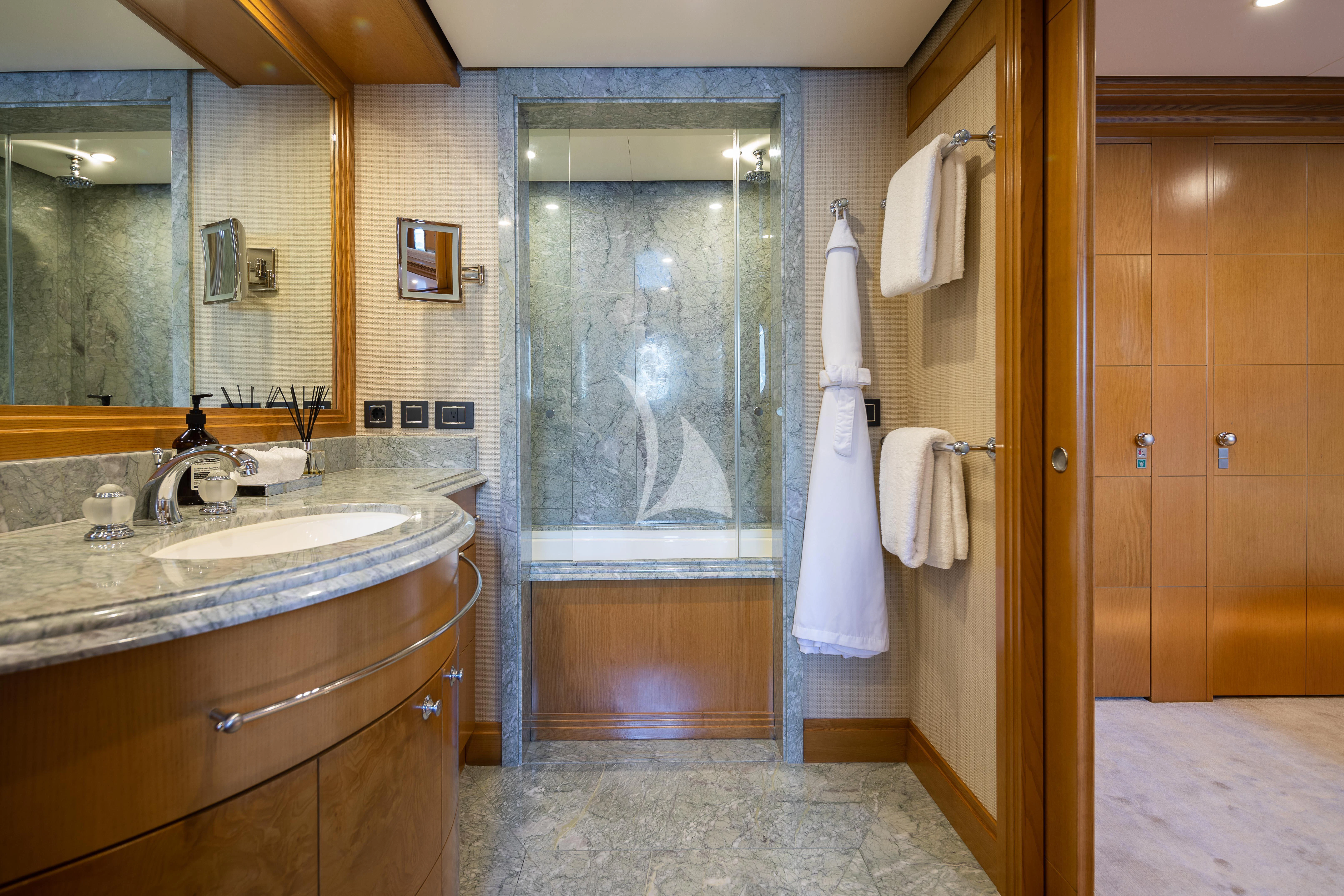 a bathroom with a glass shower door aboard TREEHOUSE Yacht for Sale