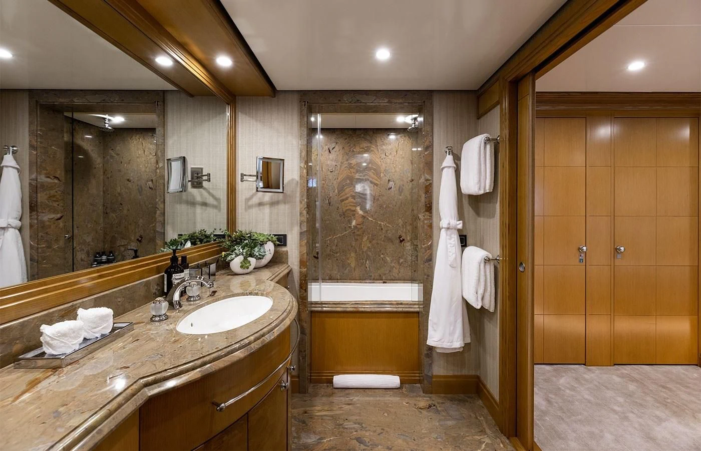 a bathroom with a sink and a bathtub aboard TREEHOUSE Yacht for Sale
