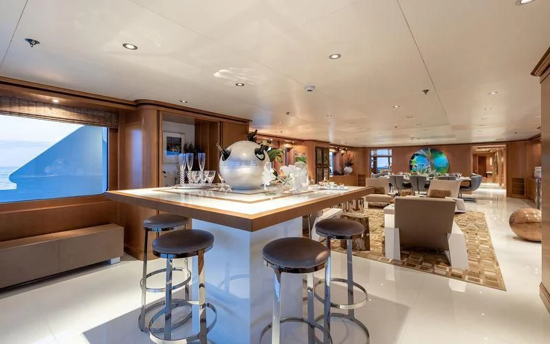 a room with a table and stools aboard TREEHOUSE Yacht for Sale
