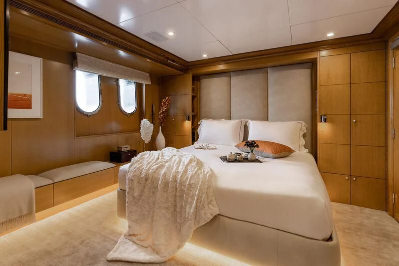 a room with a bed and a mirror aboard TREEHOUSE Yacht for Sale