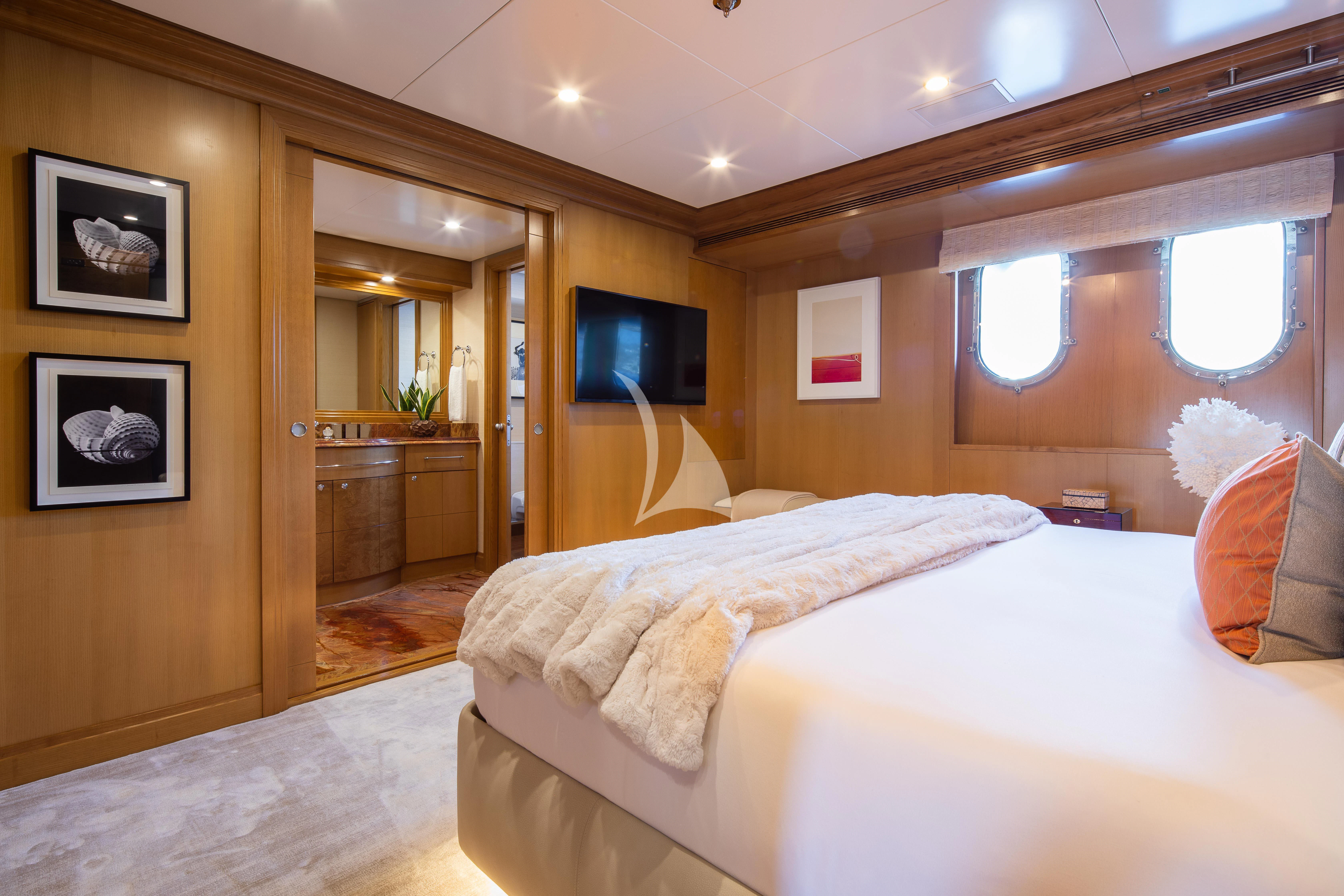 a hotel room with a bed and tv aboard TREEHOUSE Yacht for Sale