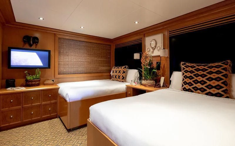 a room with a bed and a tv aboard TREEHOUSE Yacht for Sale