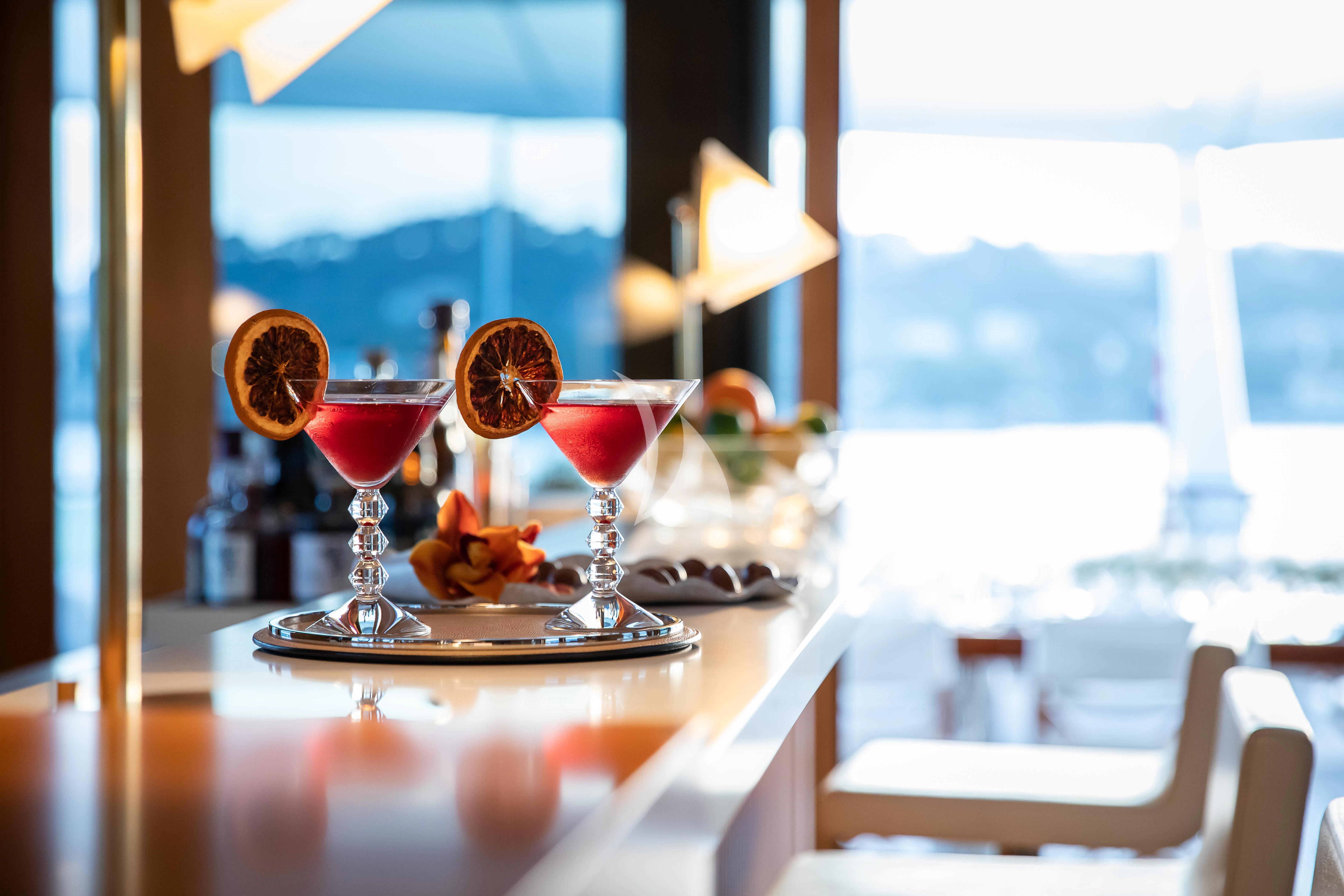 a table with glasses of wine aboard TREEHOUSE Yacht for Sale