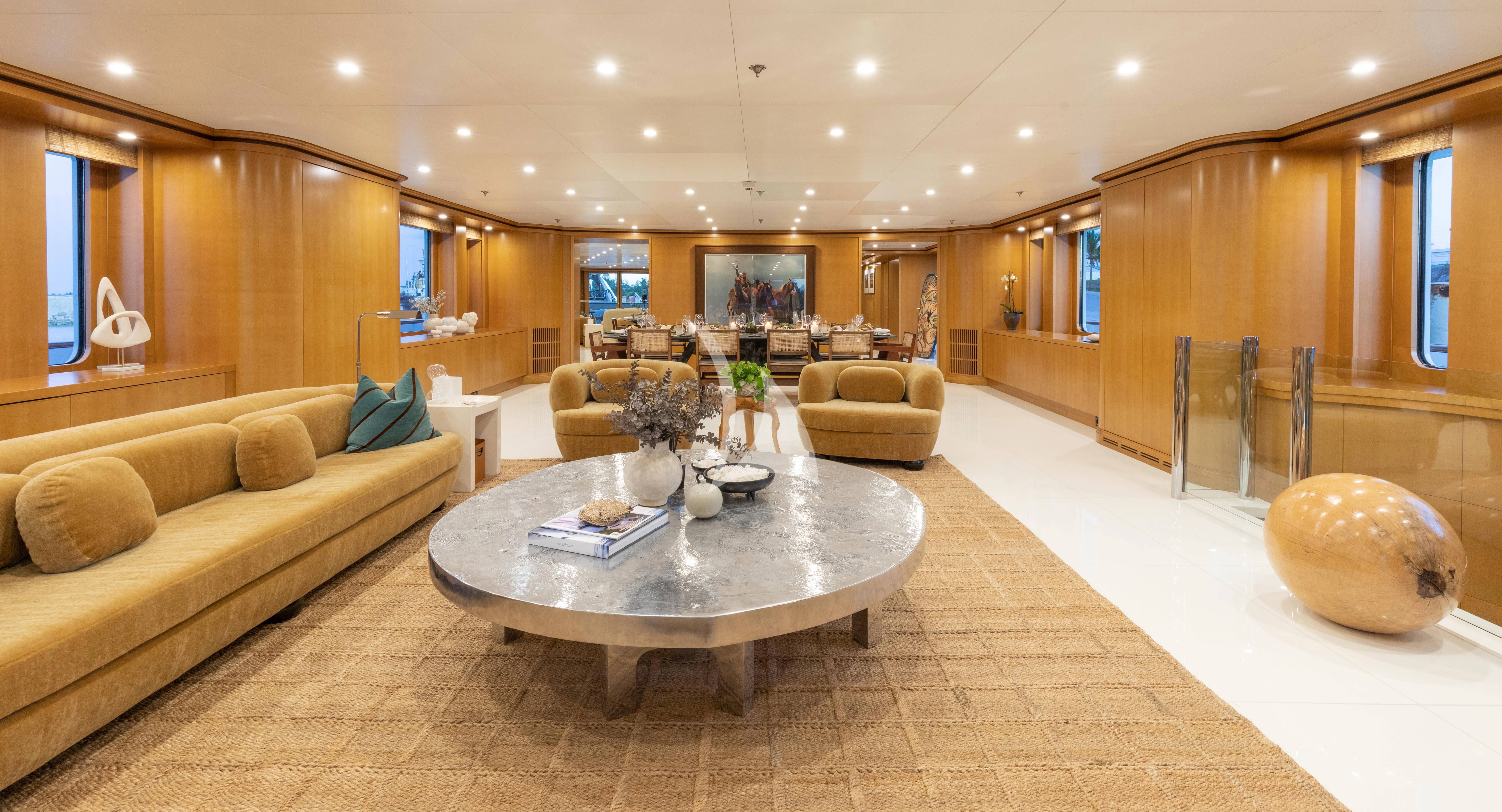 a living room with a large sofa aboard TREEHOUSE Yacht for Sale