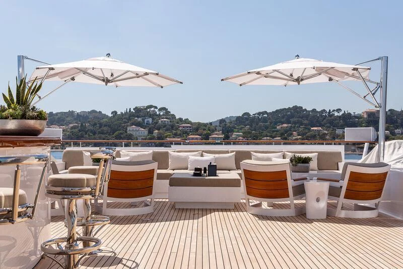 a table and chairs on a patio aboard TREEHOUSE Yacht for Sale