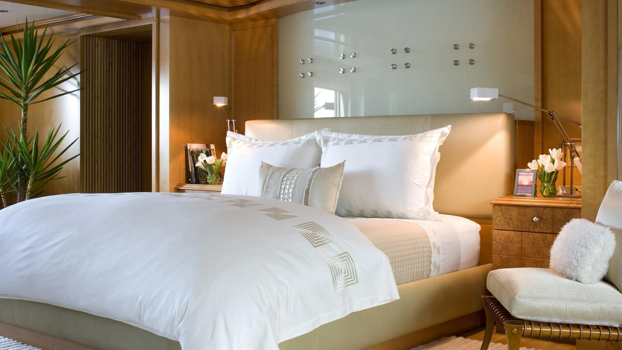a bed with white sheets aboard TREEHOUSE Yacht for Sale