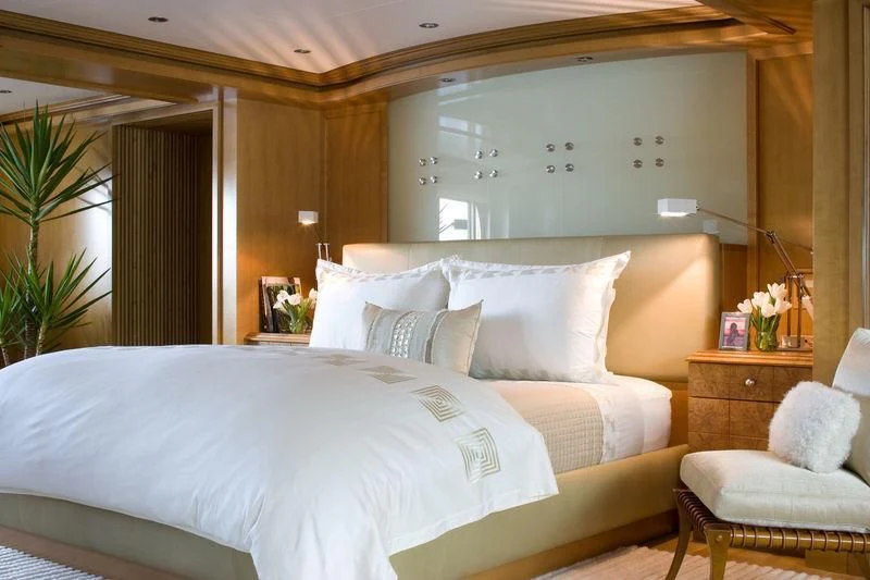 a bed with white sheets aboard TREEHOUSE Yacht for Sale