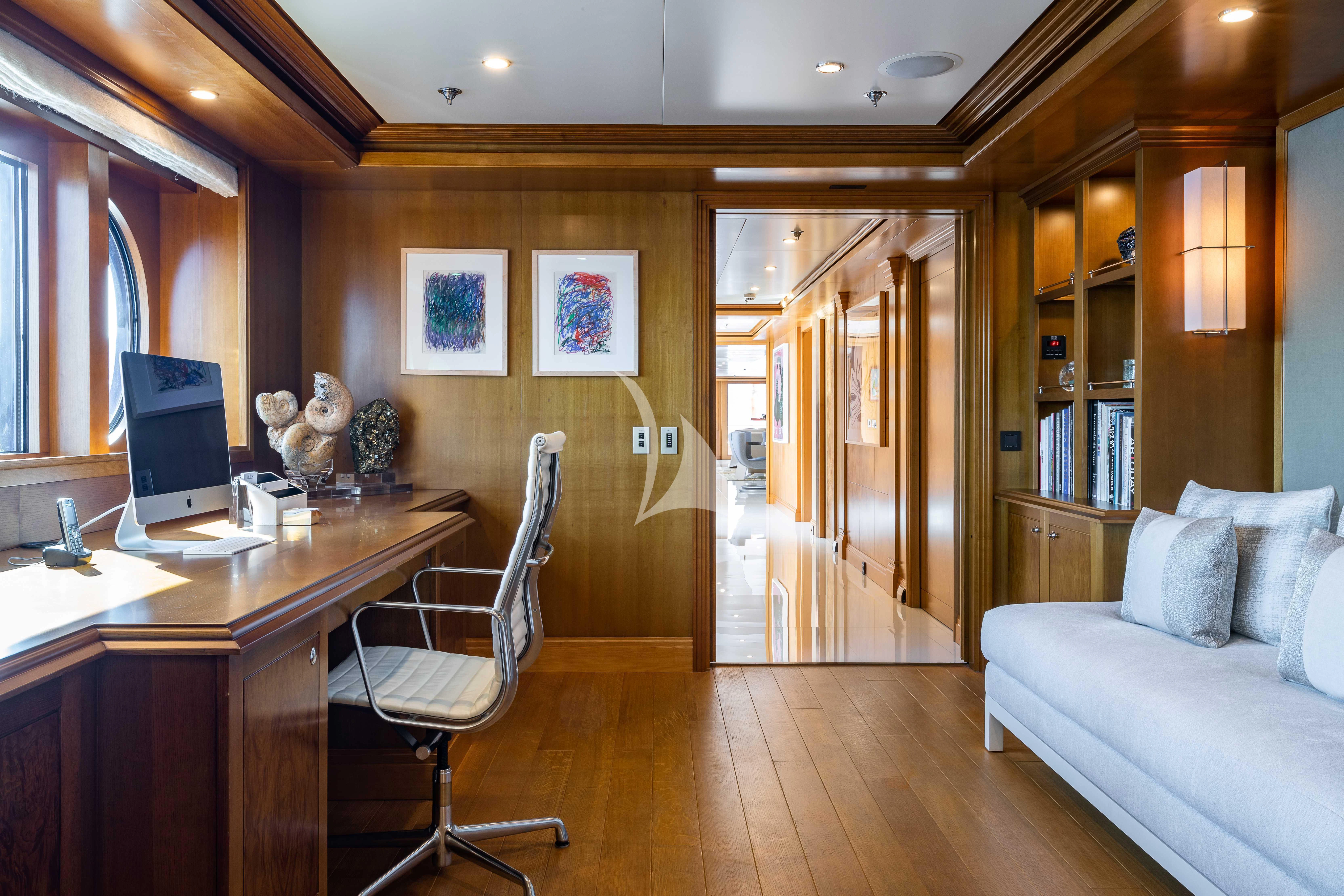 a room with a desk and a bed aboard TREEHOUSE Yacht for Sale