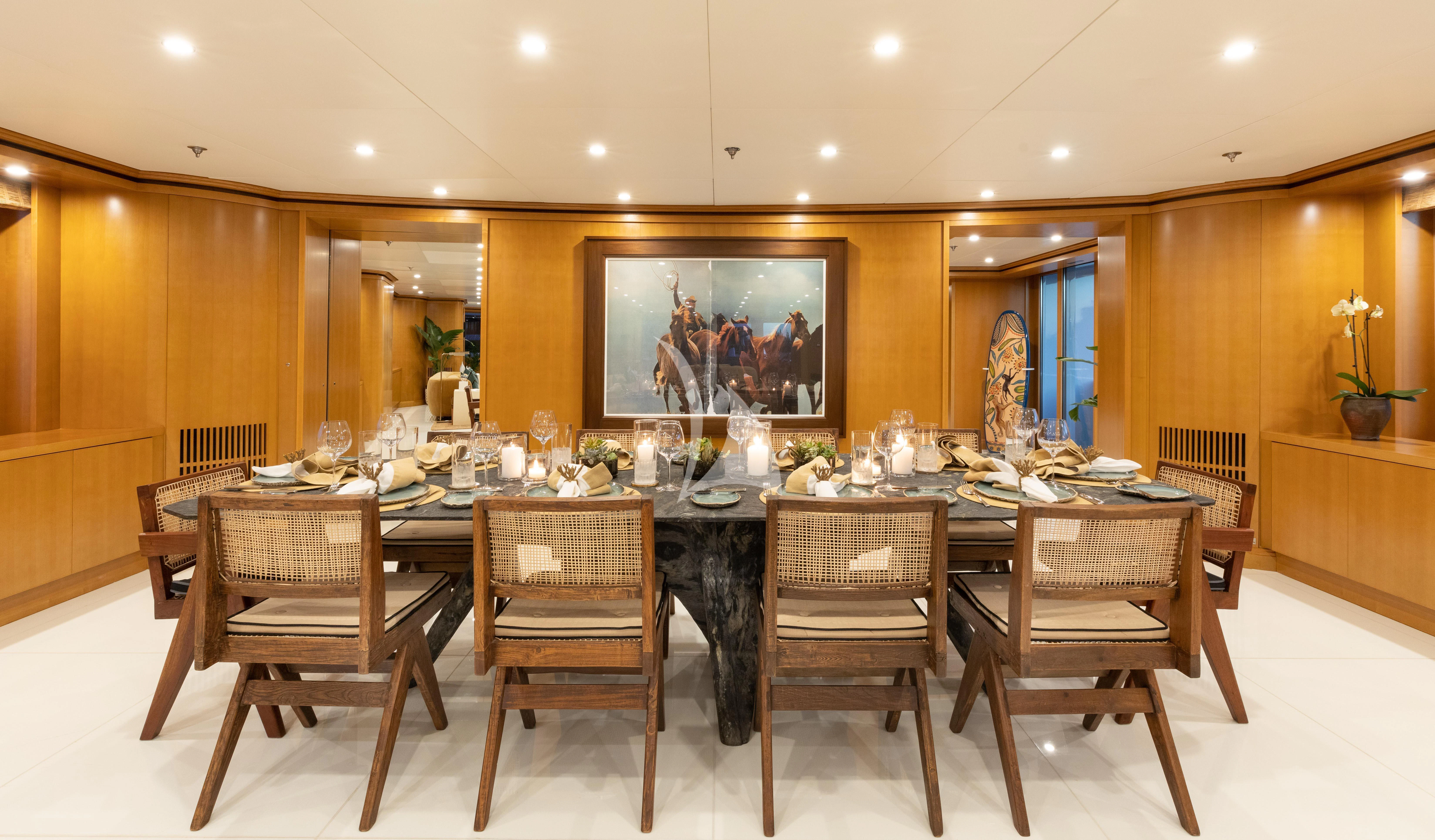 a large dining table with chairs aboard TREEHOUSE Yacht for Sale