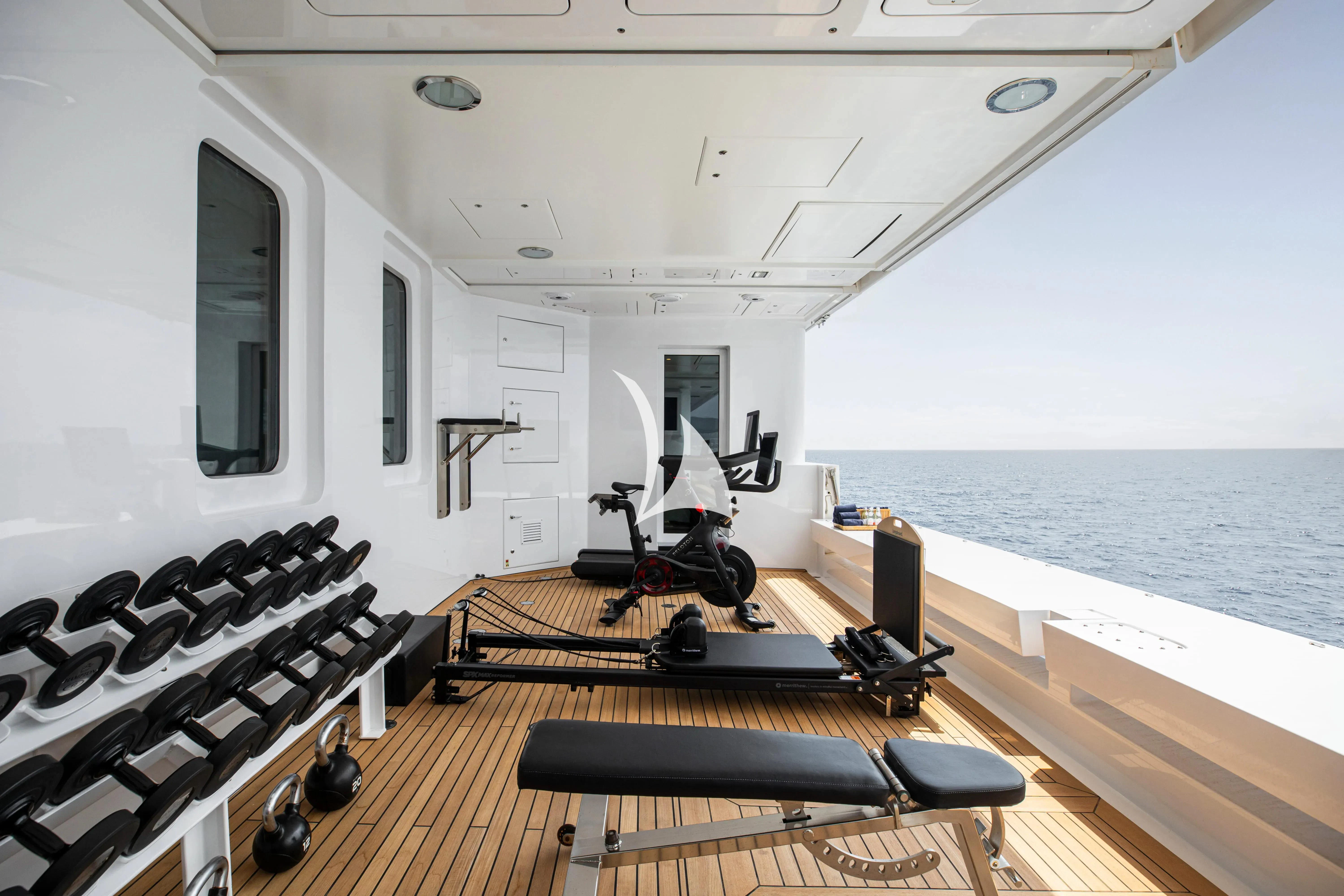 a room with a large deck and a large body of water aboard TREEHOUSE Yacht for Sale