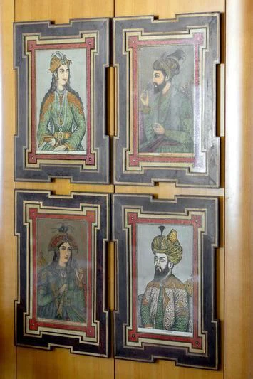 a group of paintings on a wall aboard TREEHOUSE Yacht for Sale