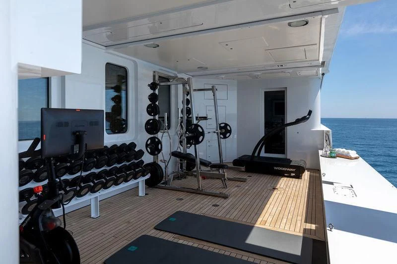 a room with a large window and a desk with a computer on it aboard TREEHOUSE Yacht for Sale