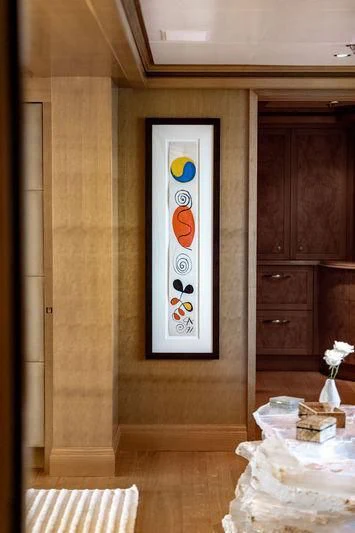 a room with a table and a painting on the wall aboard TREEHOUSE Yacht for Sale