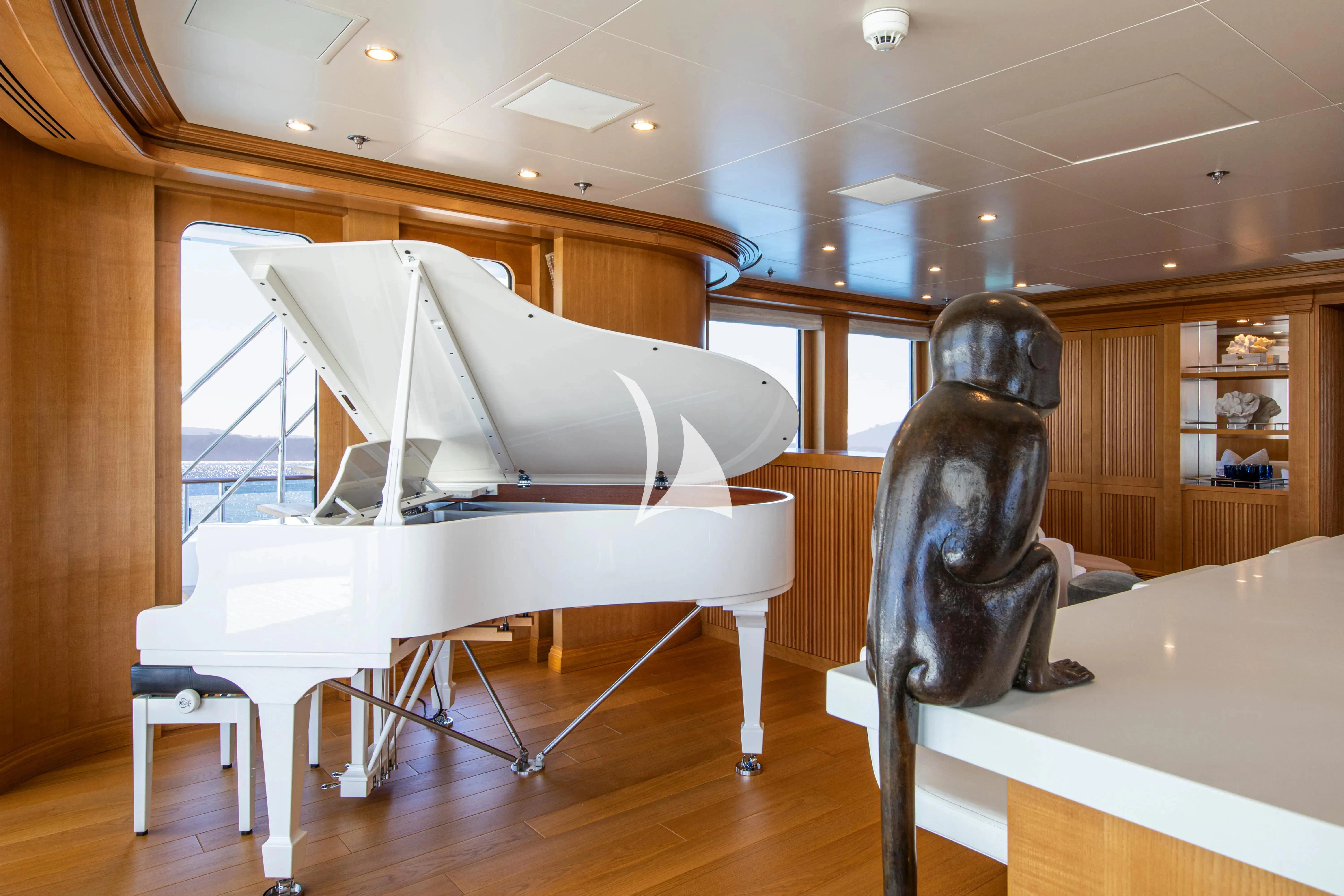 a large black object on a stand in a room with a wood floor aboard TREEHOUSE Yacht for Sale