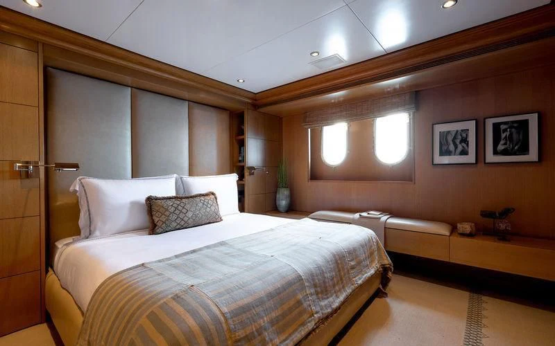 a room with a bed and a desk aboard TREEHOUSE Yacht for Sale