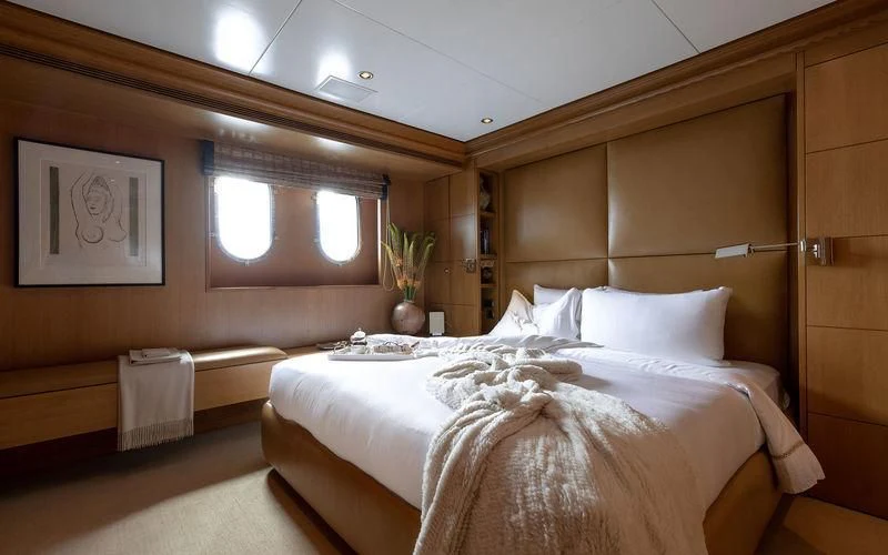 a room with a bed and a table aboard TREEHOUSE Yacht for Sale