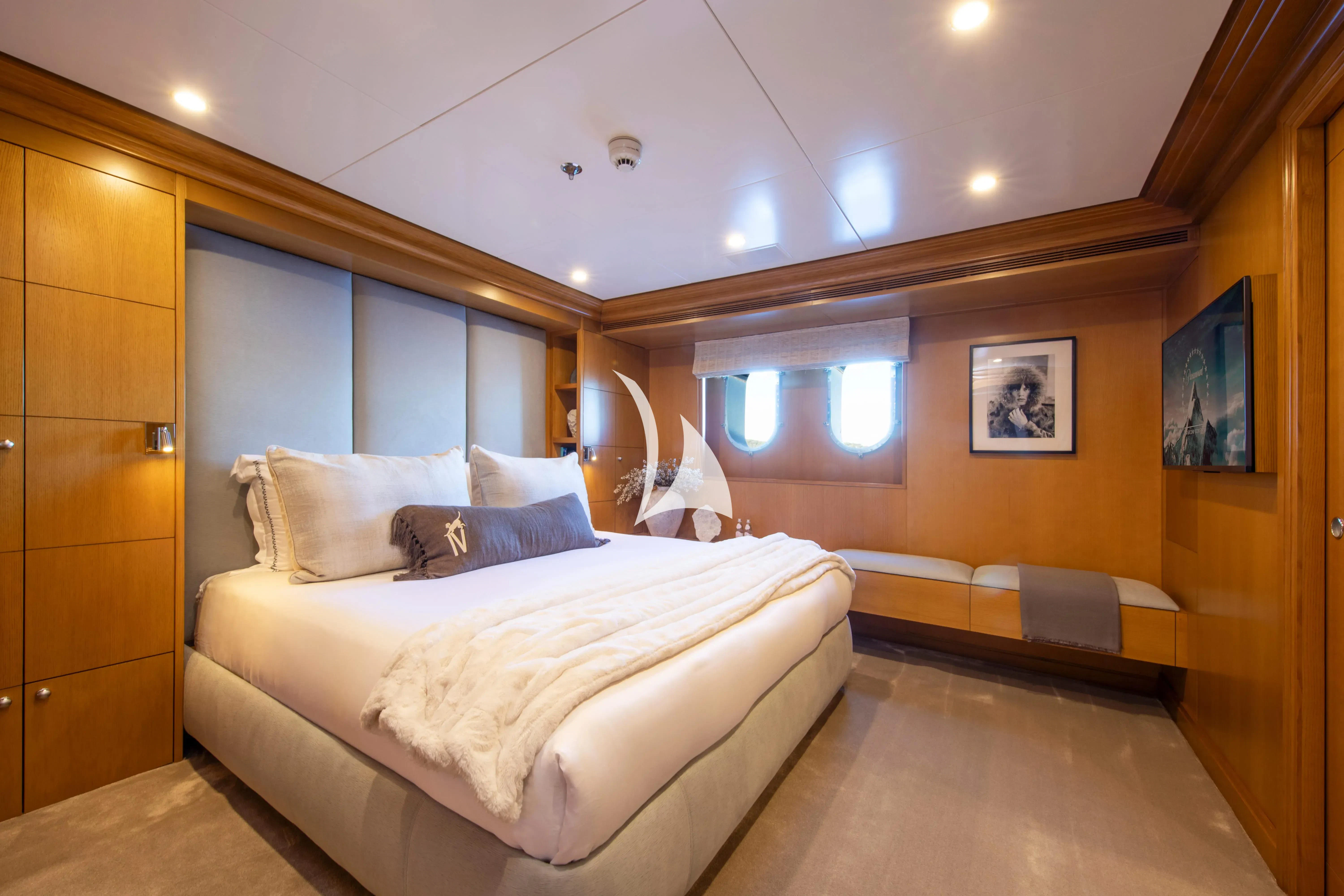 a room with a bed and a window aboard TREEHOUSE Yacht for Sale