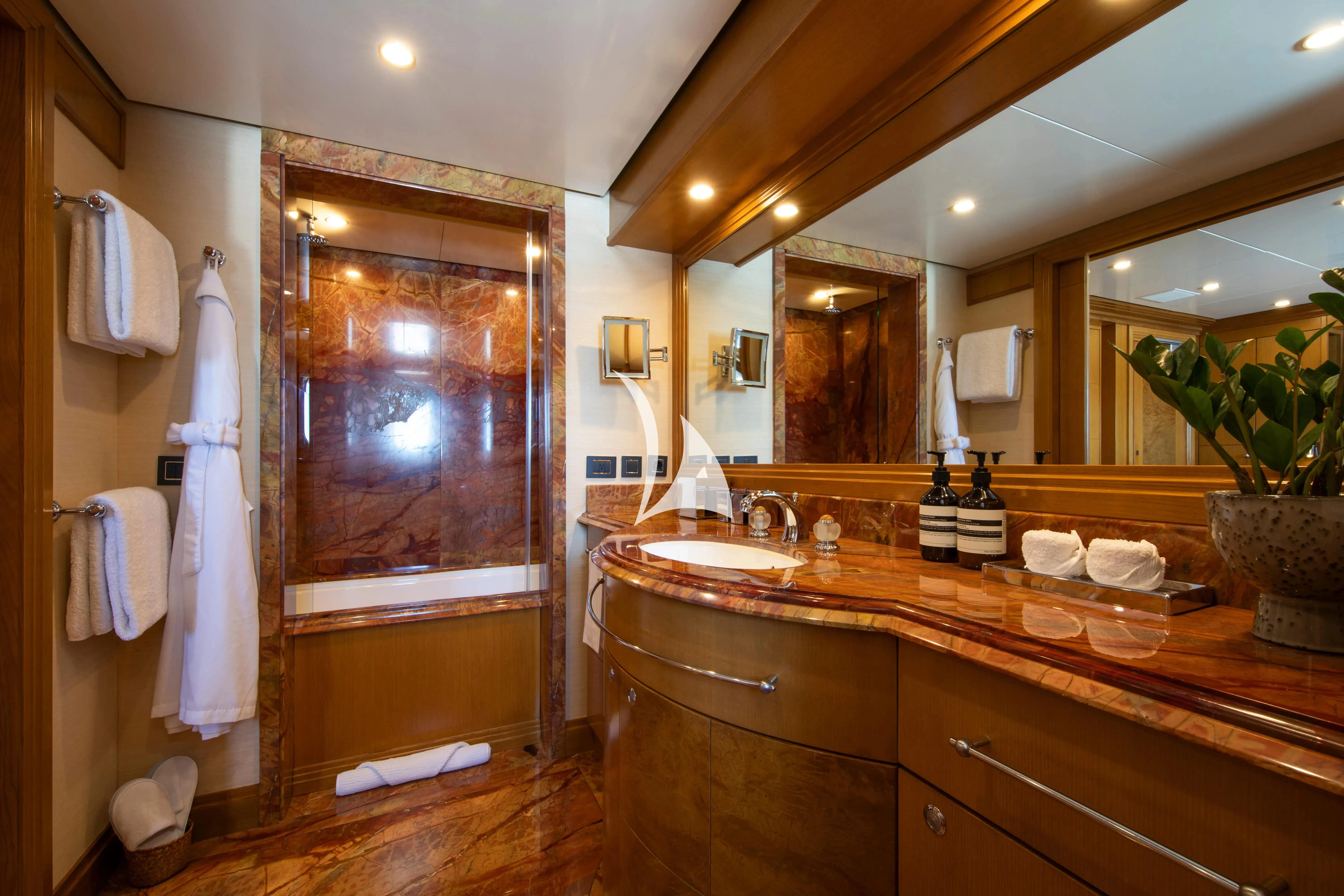 a bathroom with a countertop sink and a large mirror aboard TREEHOUSE Yacht for Sale