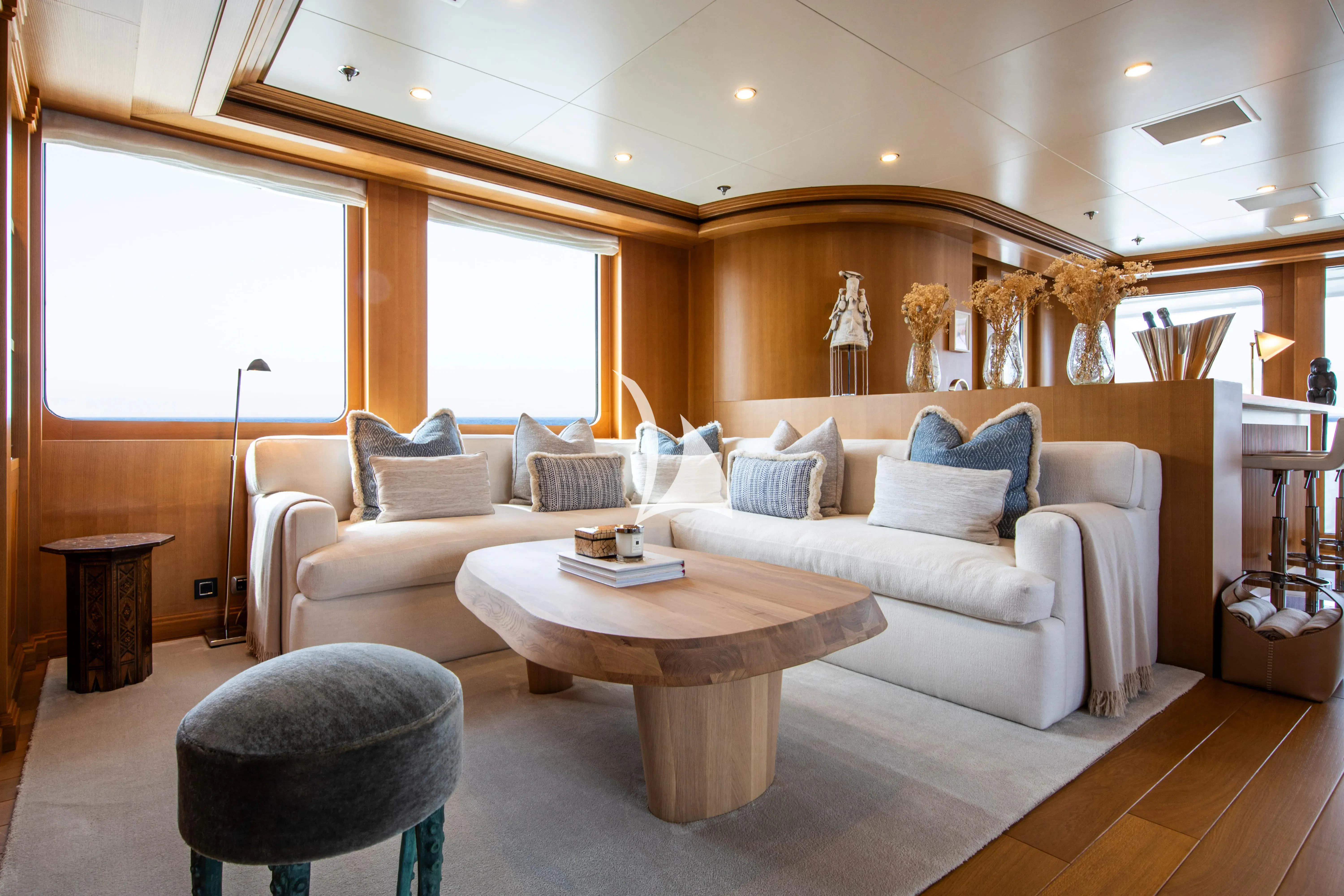 a living room with a couch and a table aboard TREEHOUSE Yacht for Sale
