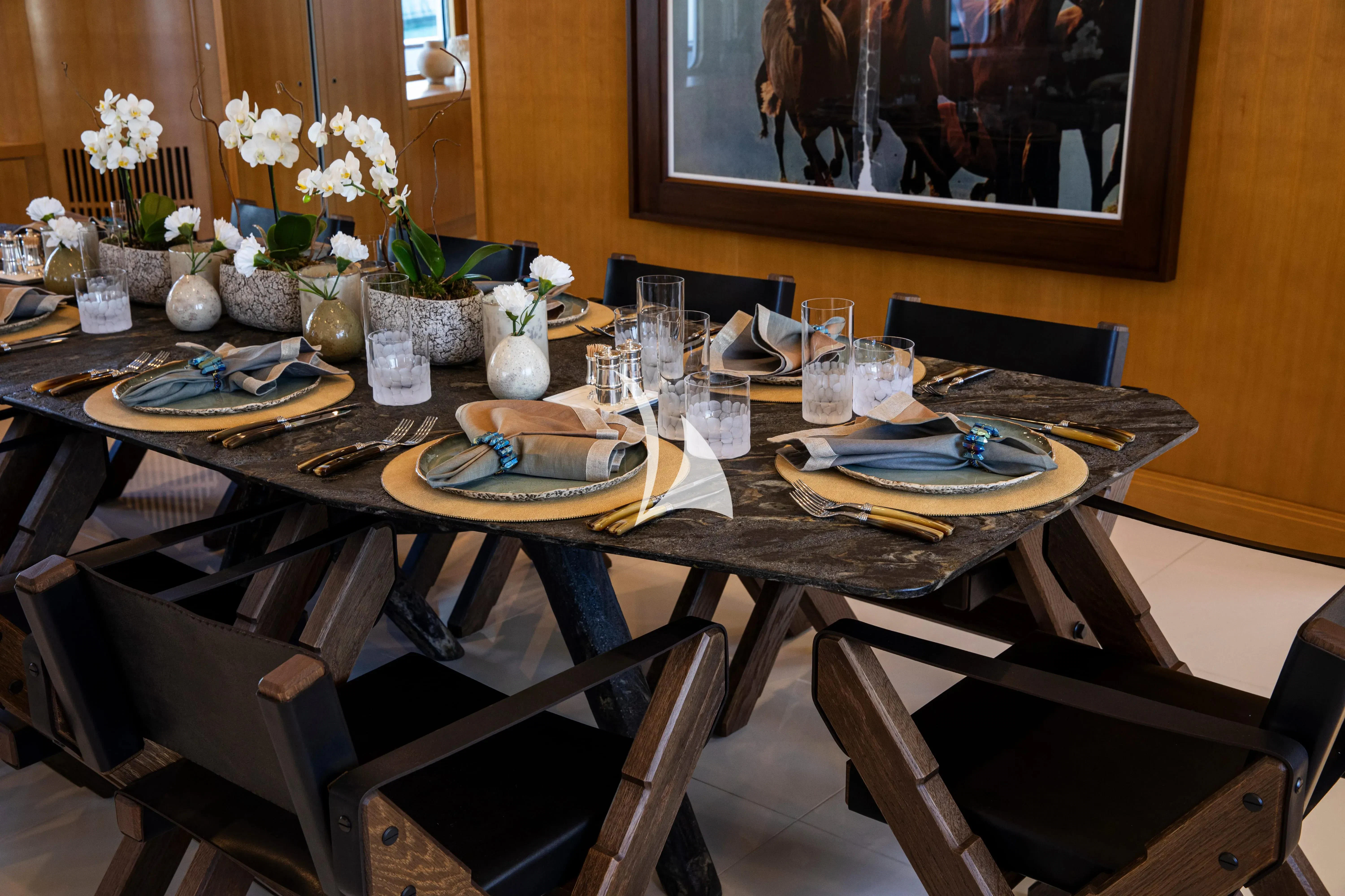 a table set with plates and glasses aboard TREEHOUSE Yacht for Sale