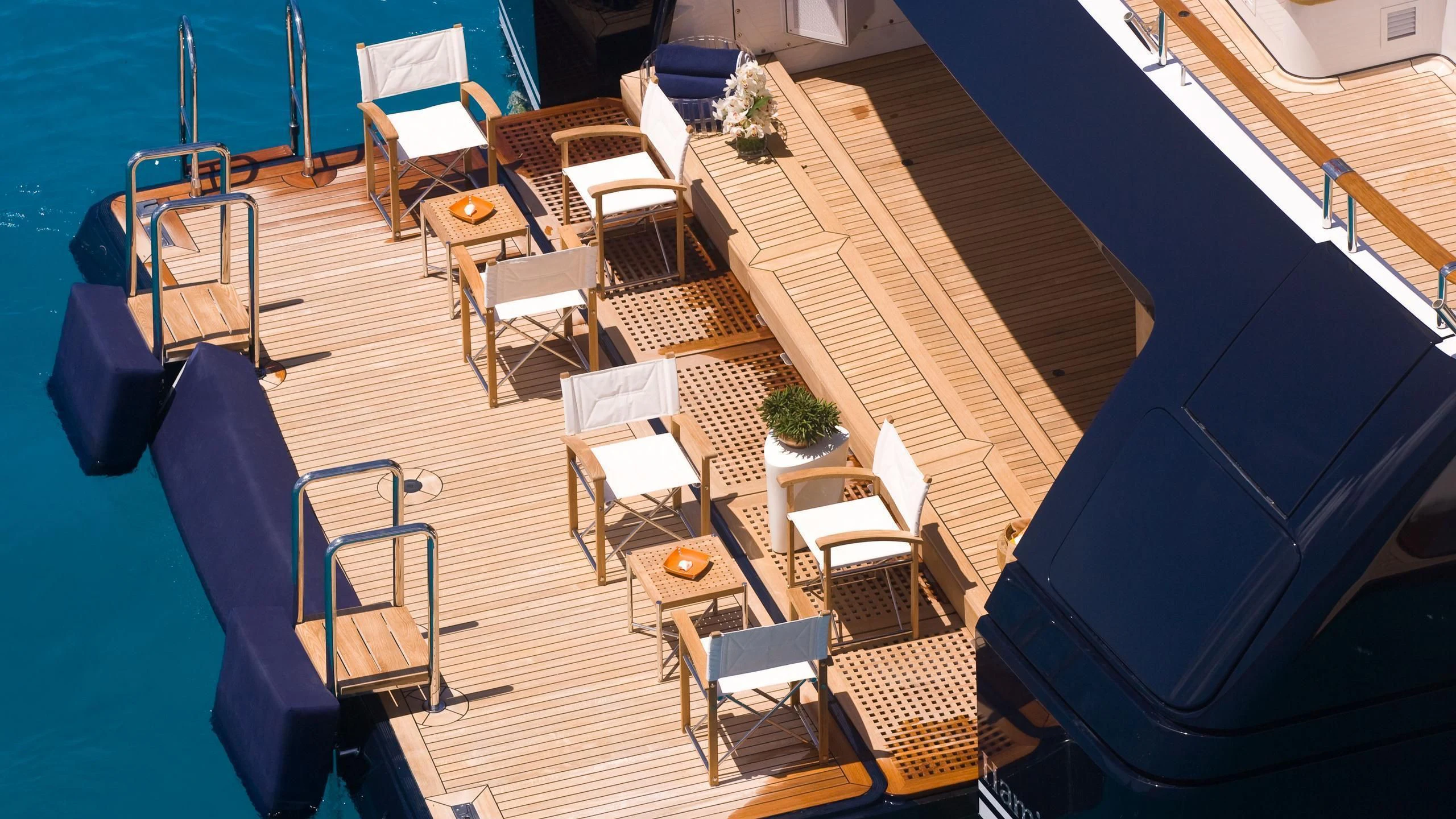a deck with chairs and tables aboard TREEHOUSE Yacht for Sale